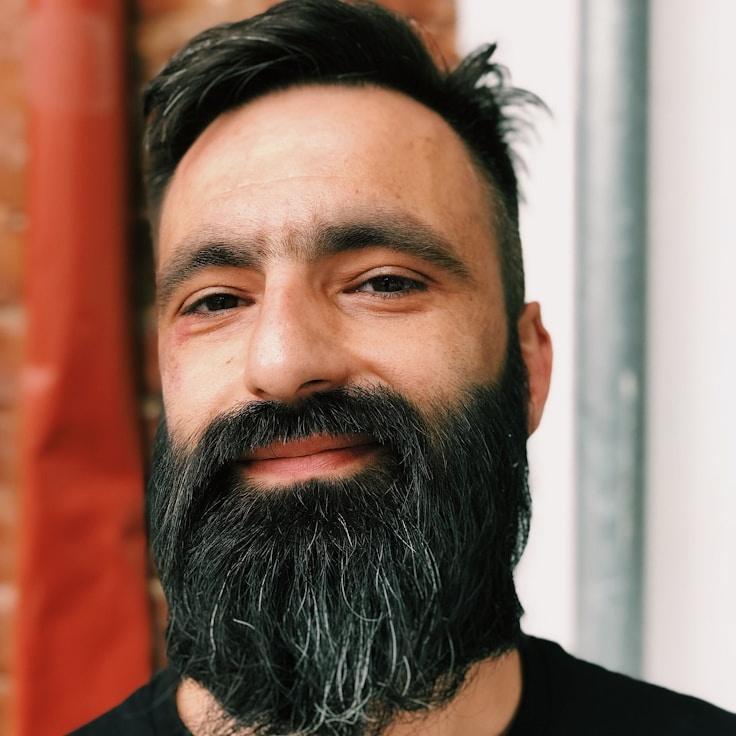 Avery Chen, Lead Design Curator at Meadow Paper Port, reviewing corporate floral arrangements